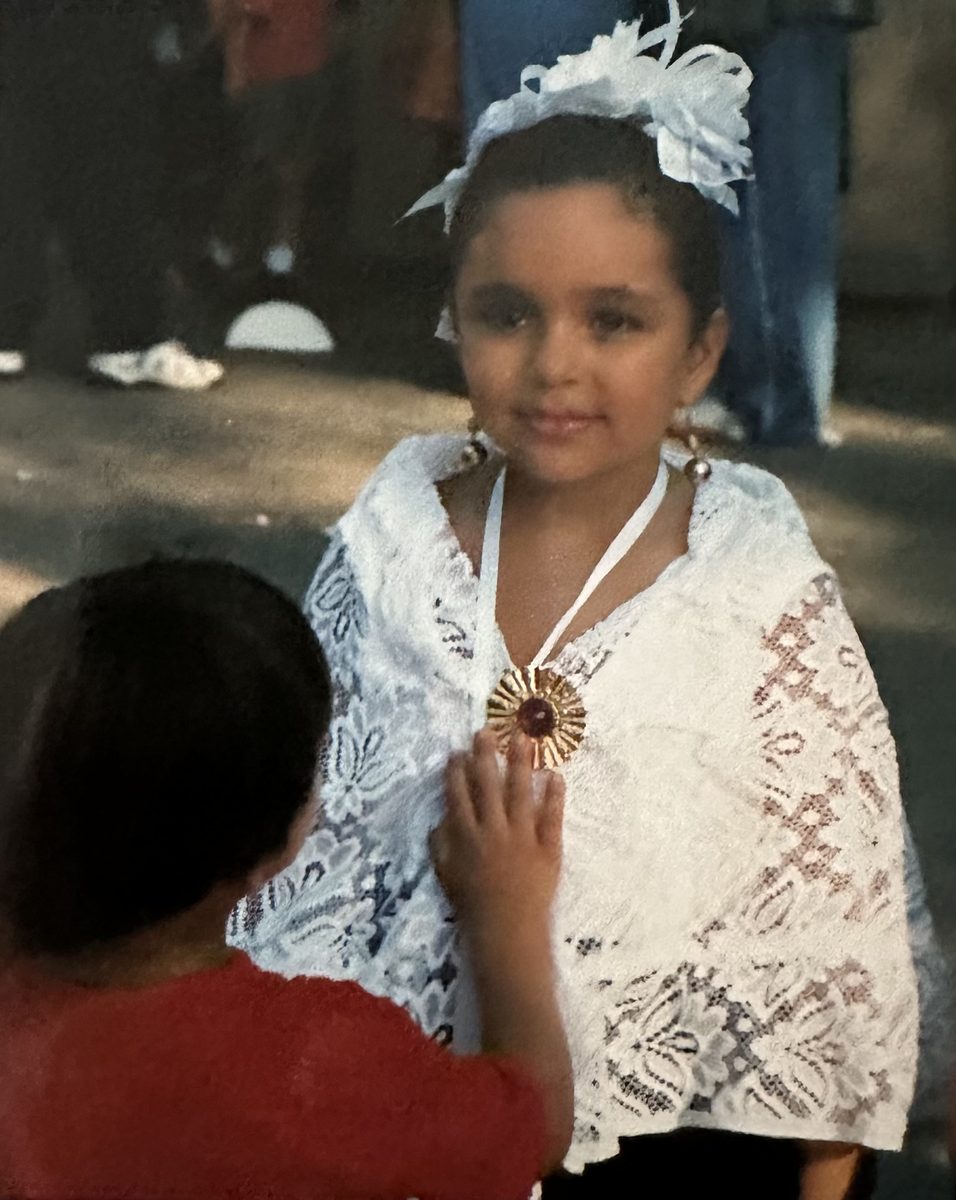 Young dancer in white lace shawl during cultural celebration